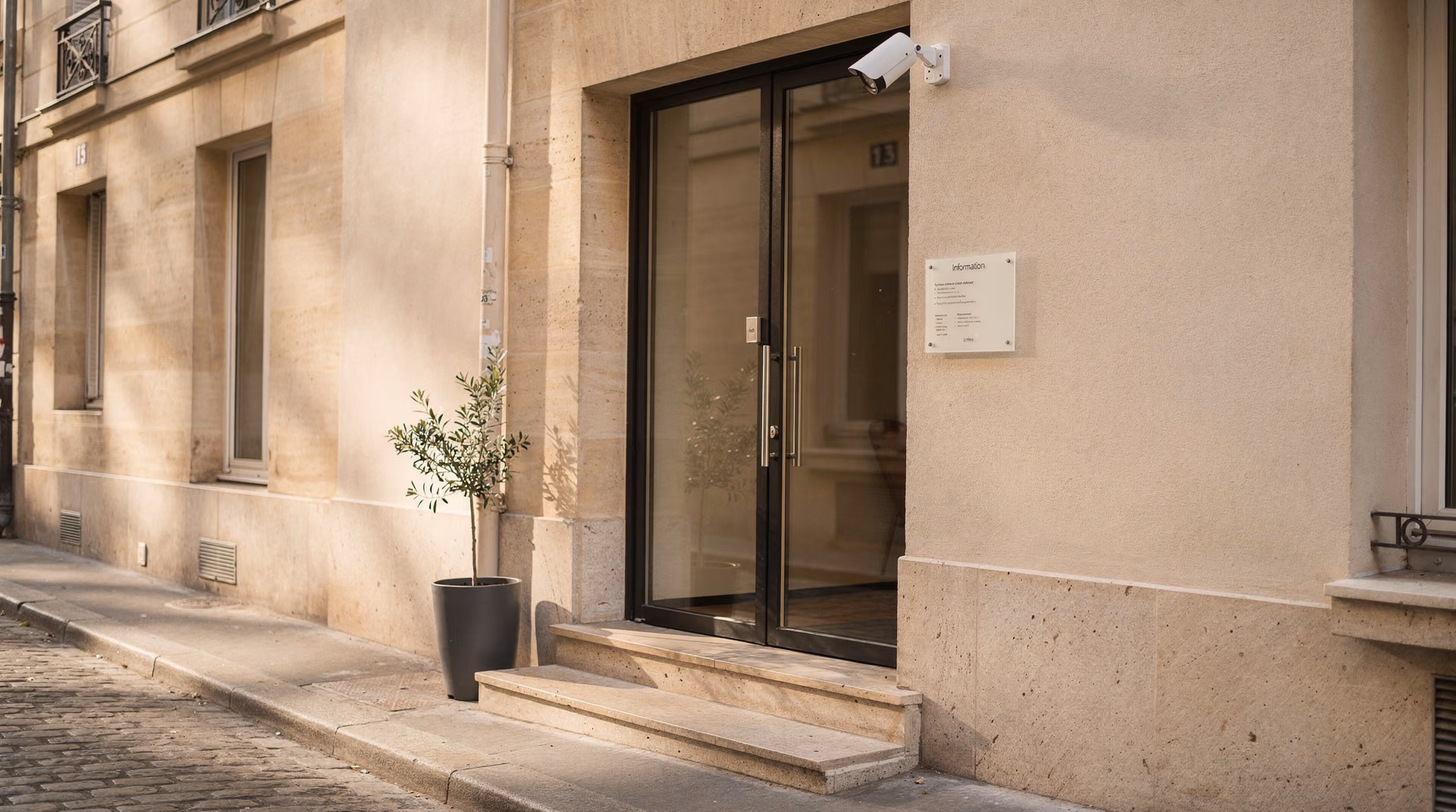 Entrée d'un appartement Airbnb avec caméra extérieure discrète et notice d'information